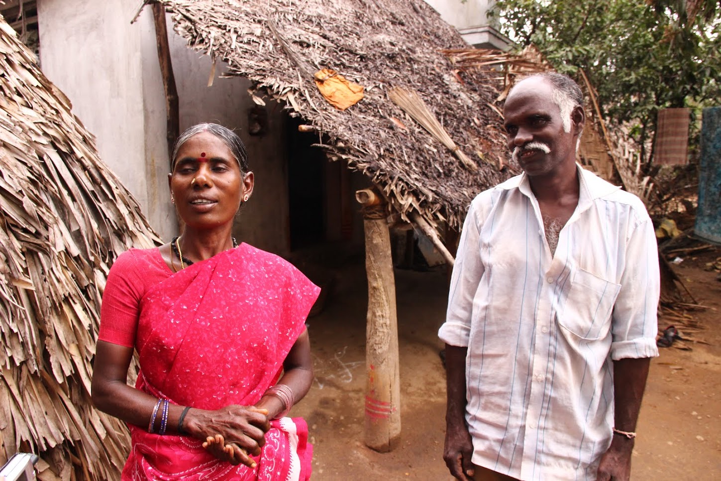 Pushpa (L) and Vadivelu, outside their house in Chenneri Village. Credit: Roy Benadict Naveen