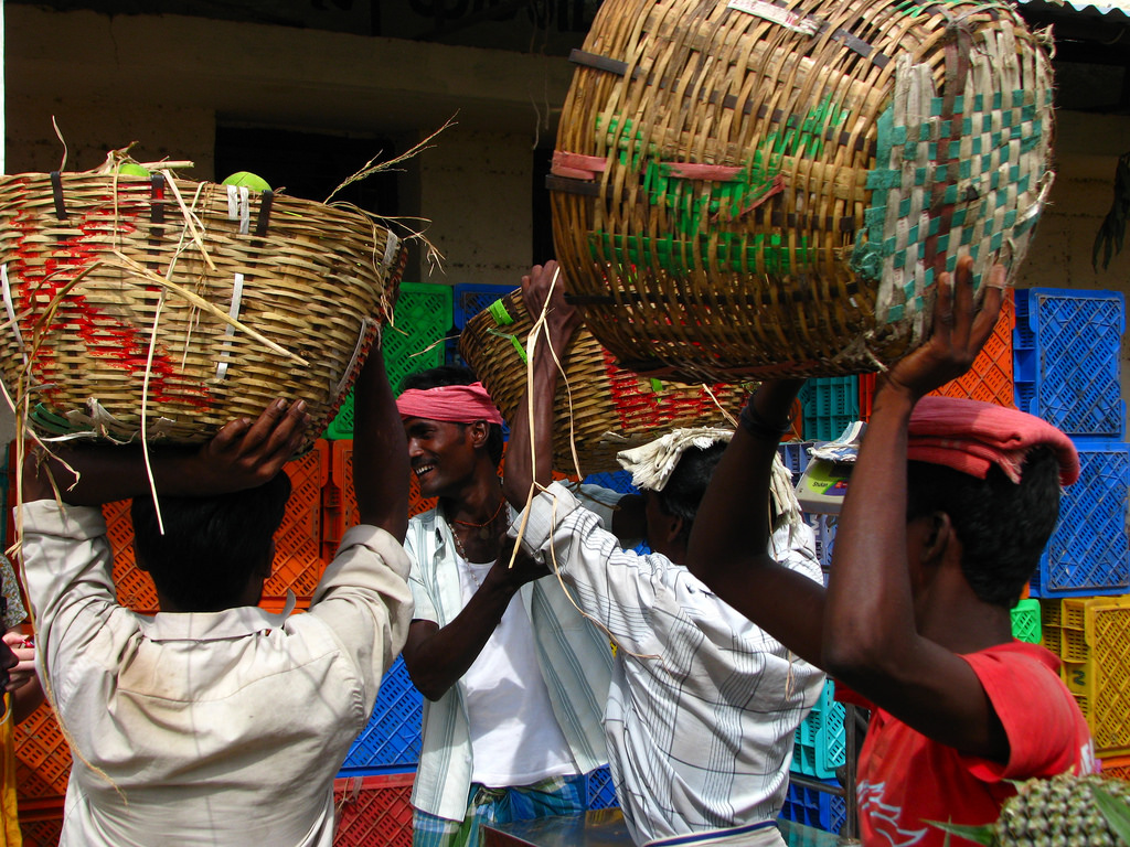 Labourers unload fresh fruits from a truck in Koyambedu Market, Chennai, 2009. Credit: mckaysavage/Flickr, CC BY 2.0