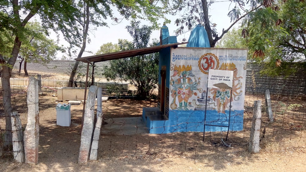 Temple beside goshala, cut off from local villages by BARC compound wall. Credit: Gaurav Mendiratta